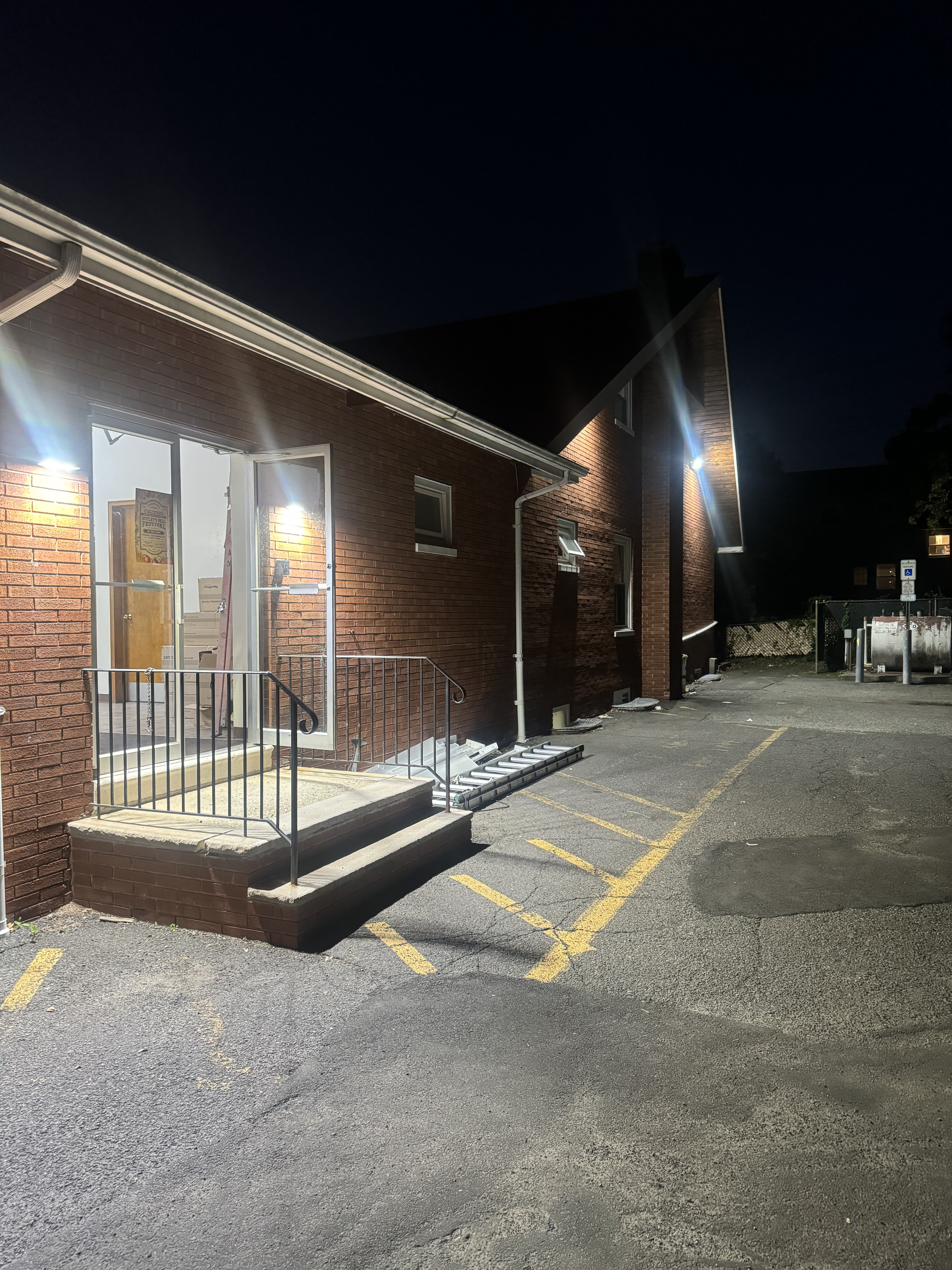 Exterior wall pack at night, brick building