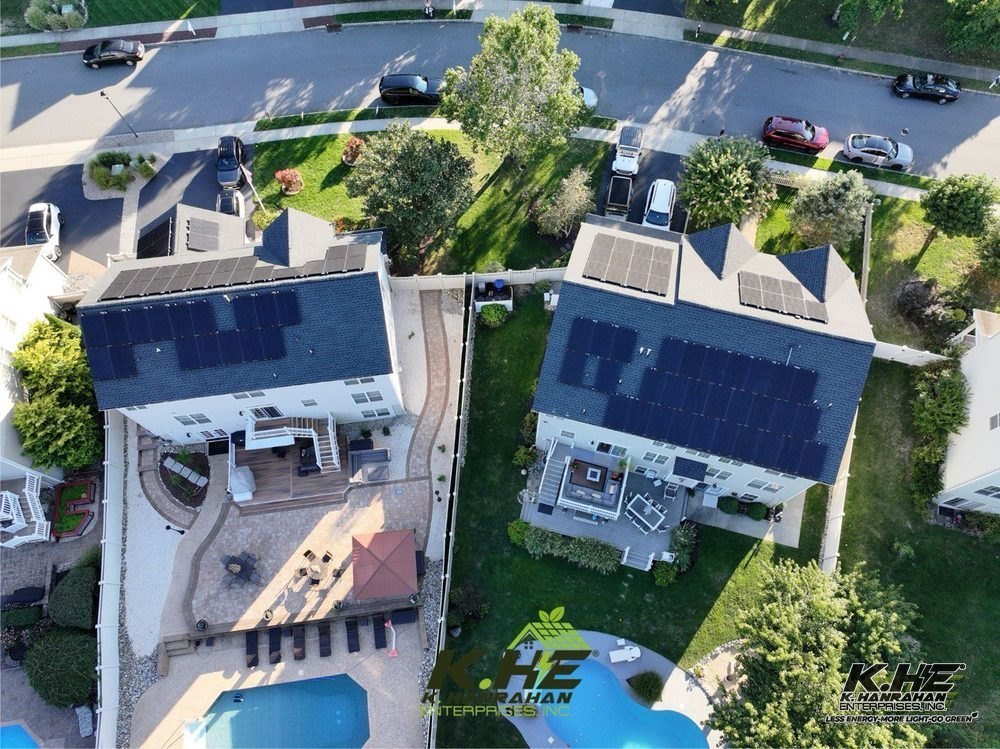 KHE solar installation — drone view of two homes with full rooftop arrays